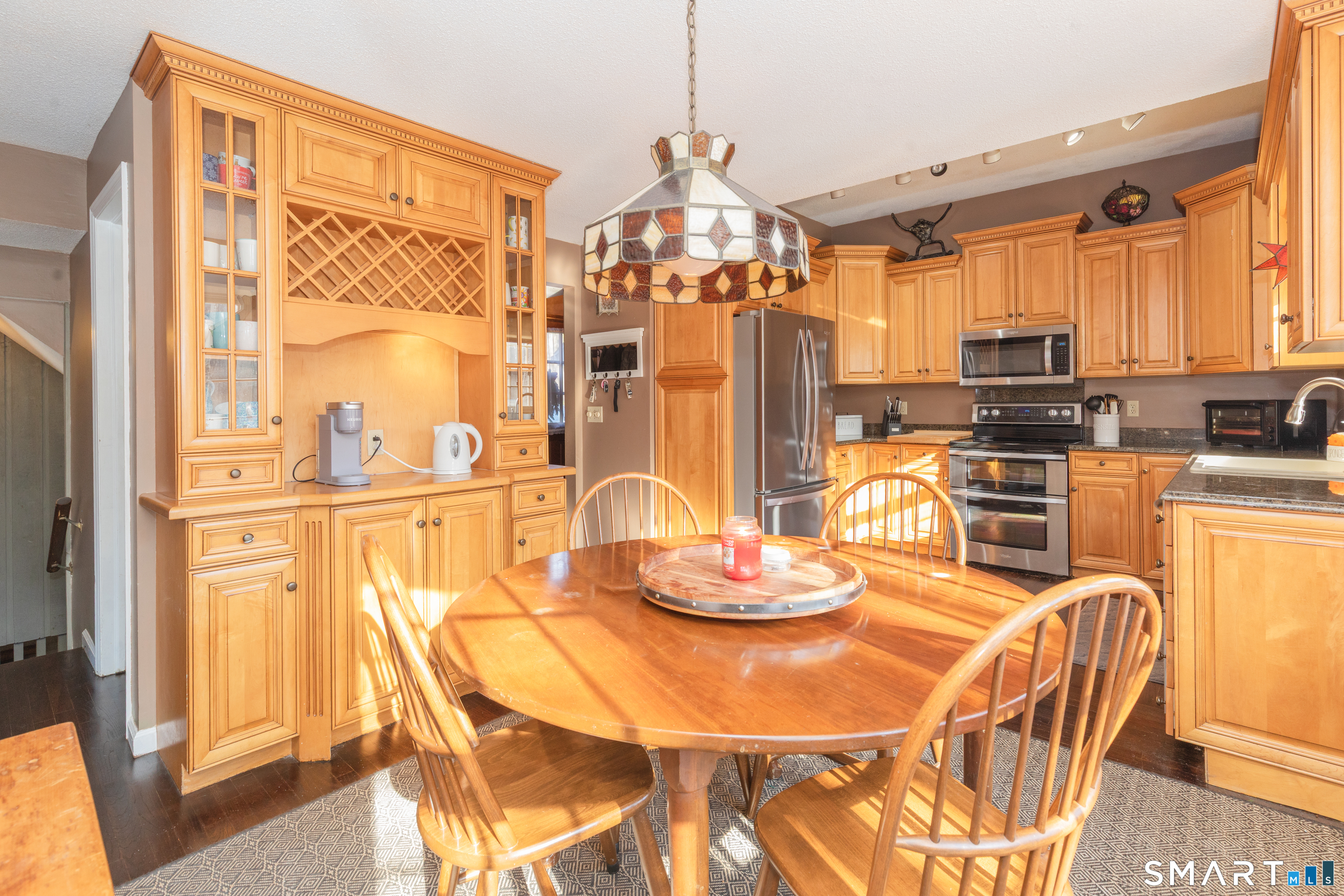 637 Watertown Road Middlebury, CT 06762 - Photo 11 of 40 a view of a dining room with furniture a kitchen and chandelier