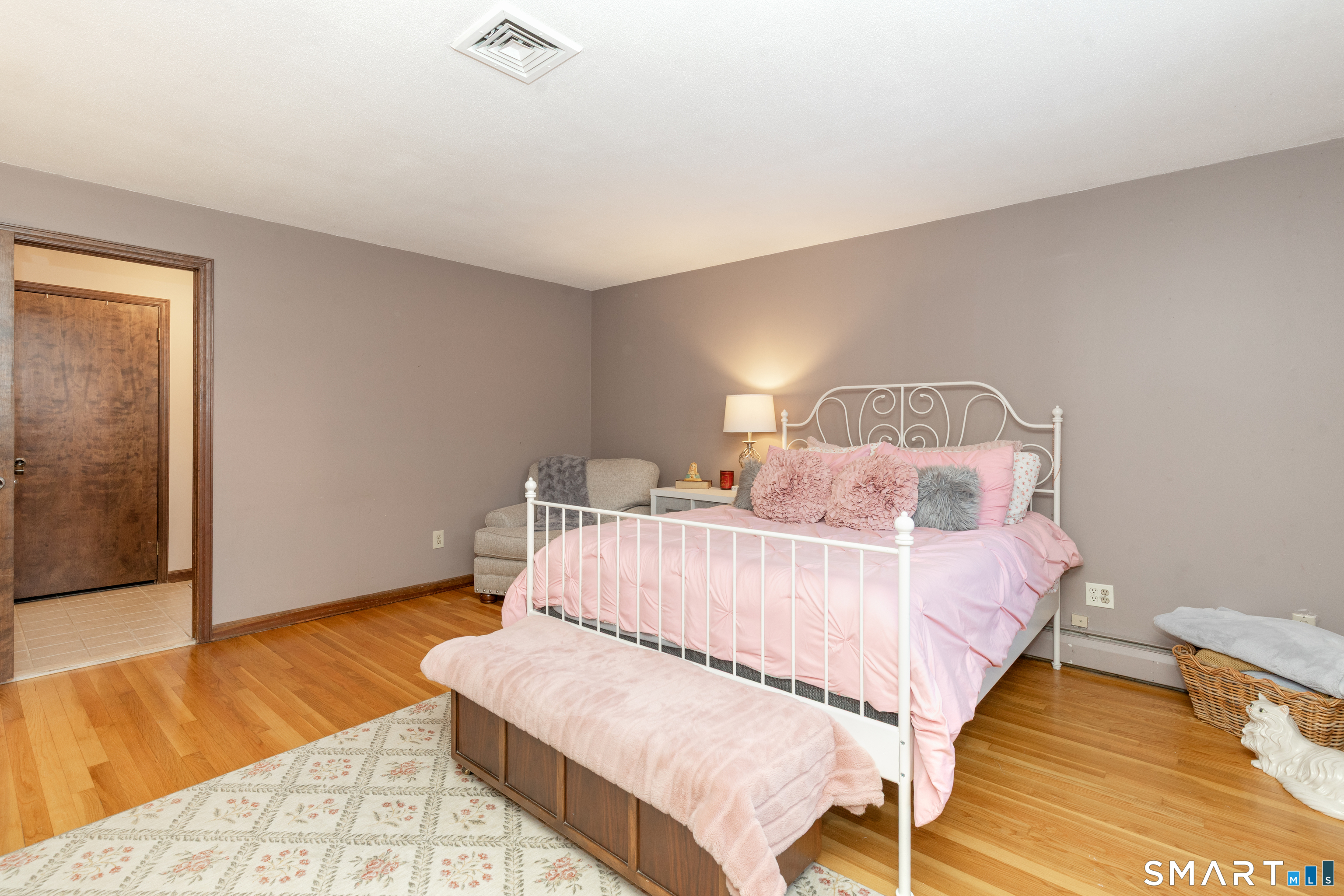 637 Watertown Road Middlebury, CT 06762 - Photo 16 of 40 a bed sitting in a bedroom next to a window with wooden floor