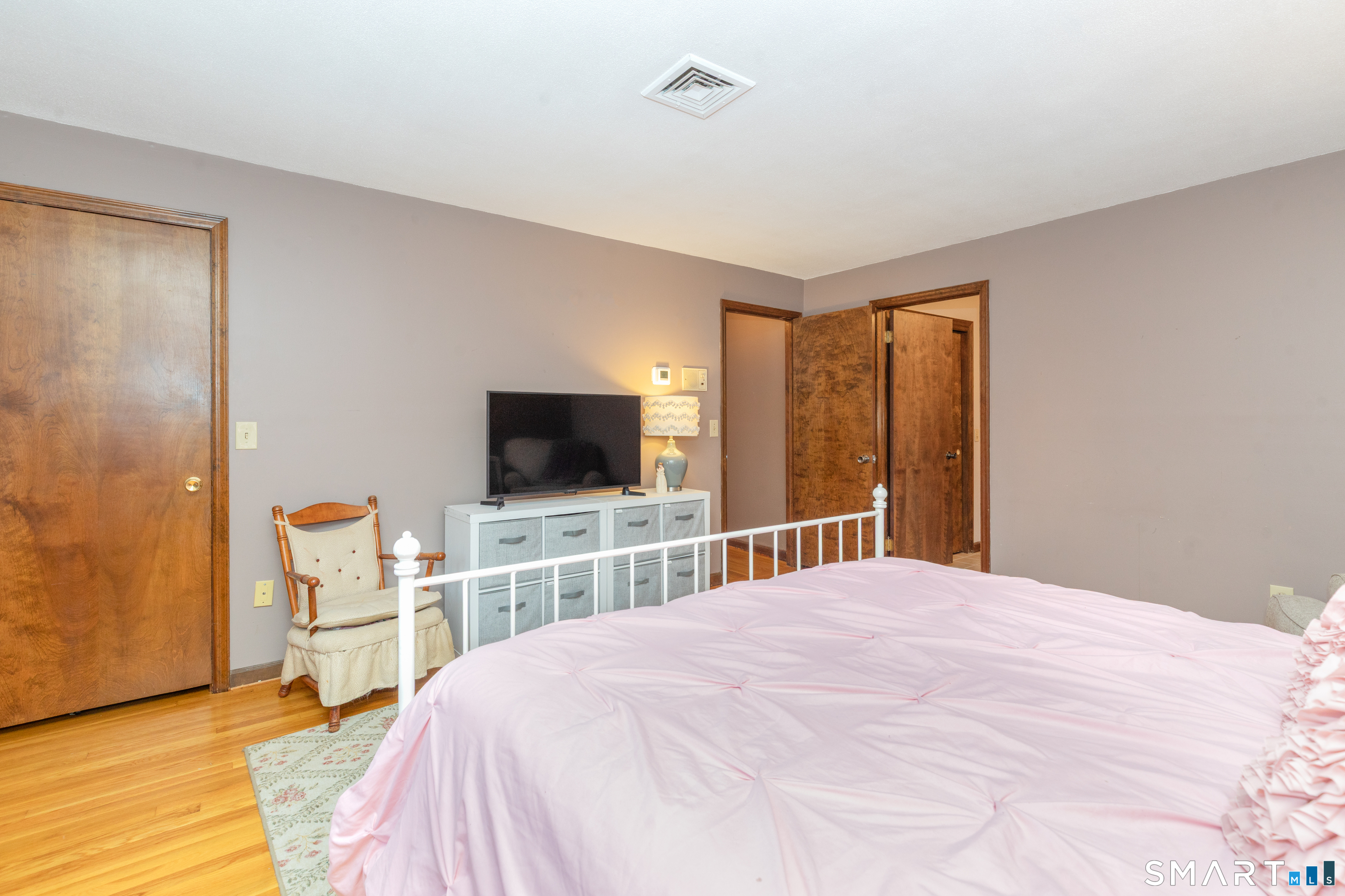 637 Watertown Road Middlebury, CT 06762 - Photo 17 of 40 a bedroom with a bed and a flat screen tv