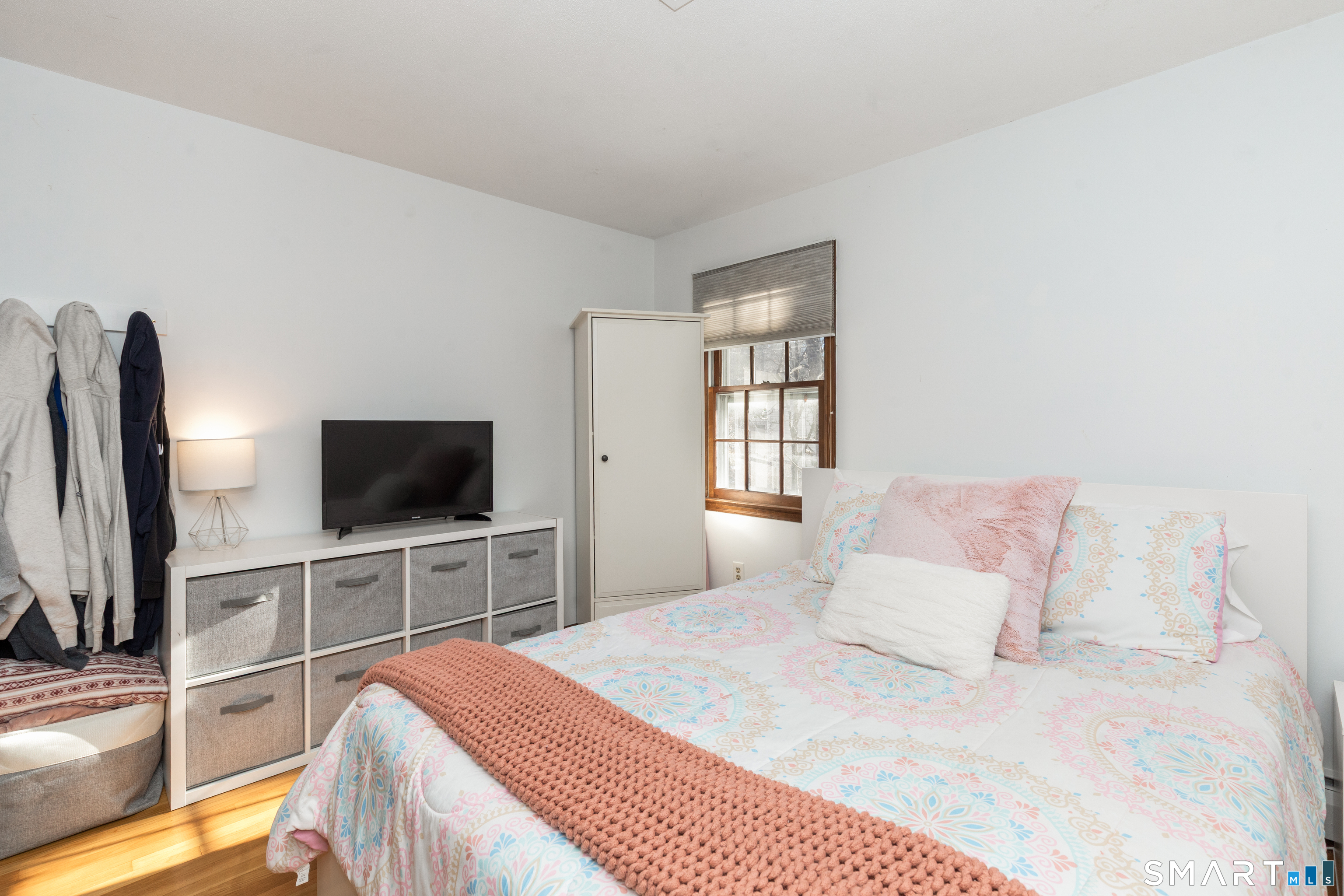 637 Watertown Road Middlebury, CT 06762 - Photo 23 of 40 a bedroom with a bed and a flat screen tv