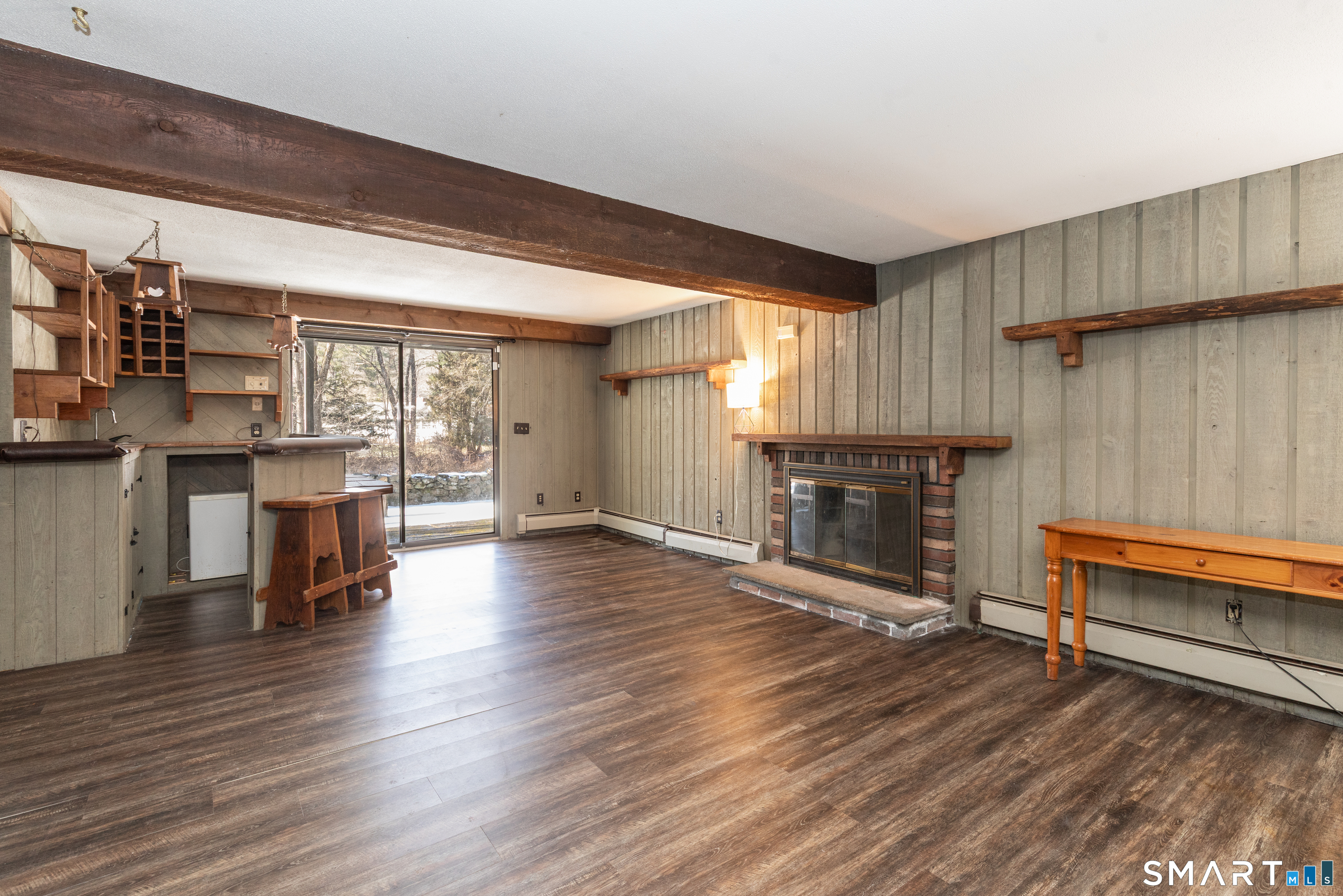 637 Watertown Road Middlebury, CT 06762 - Photo 25 of 40 an empty room with wooden floor and fireplace