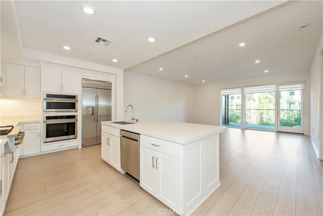 a kitchen with stainless steel appliances a stove sink and cabinets