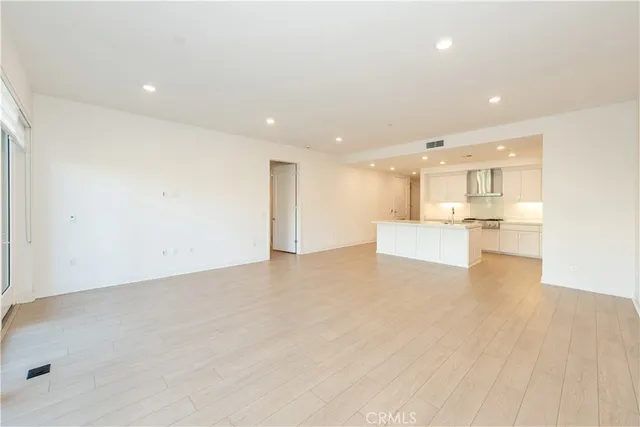 a view of kitchen with kitchen island and stainless steel appliances