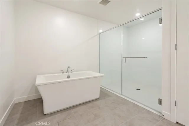 a bathroom with a bathtub and shower