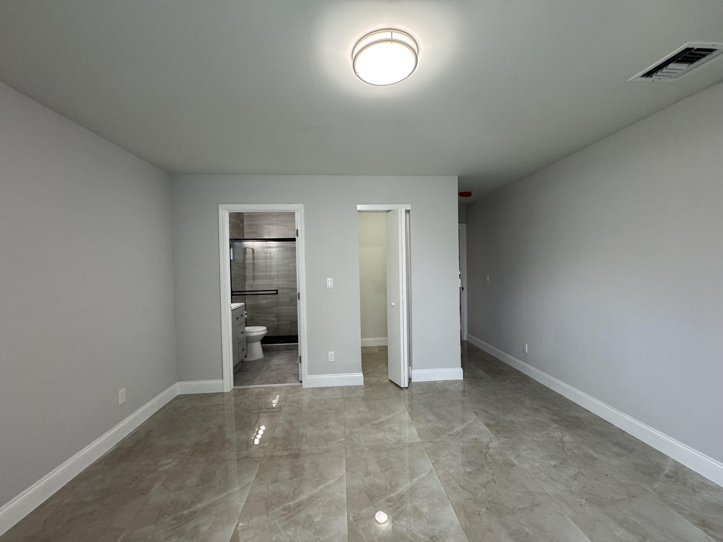400 Northeast 30th Street, Unit 2 Pompano Beach, FL 33064 - Photo 12 of 22 an empty room with closet and a window
