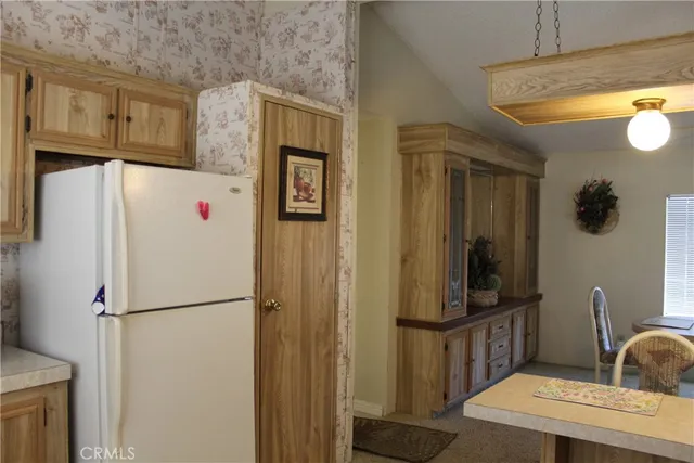 a kitchen with stainless steel appliances a refrigerator and cabinets