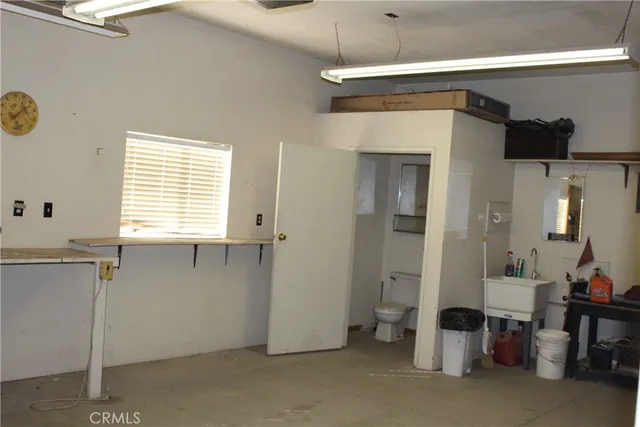 a bathroom with a granite countertop sink and a shower