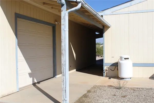 a view of a dry yard with wooden fence