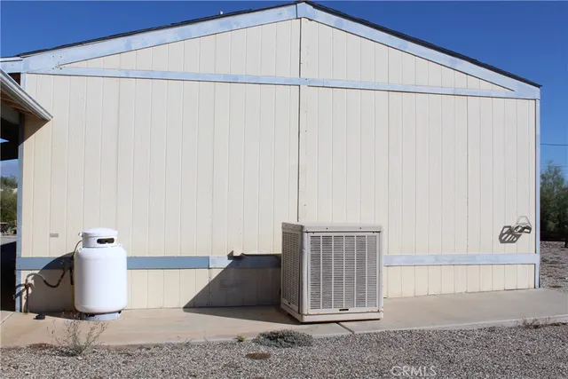 a view of a park with a bench and large trees