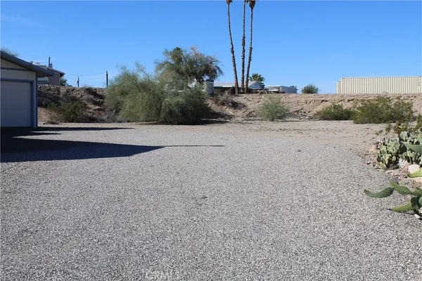 a view of a dry yard with a road