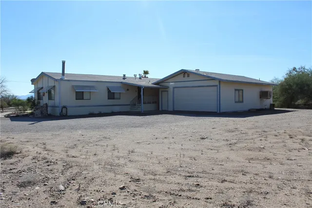 a view of a house with wooden fence