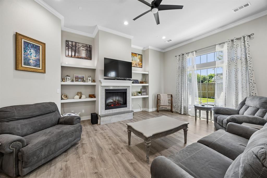 612 Frisco Road Sherman, TX 75090 - Photo 15 of 25 Living area featuring wood-finish flooring and crown molding