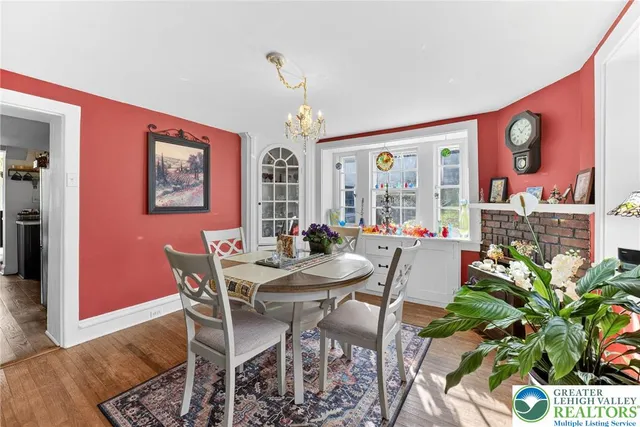 a living room with furniture a fireplace and a large window