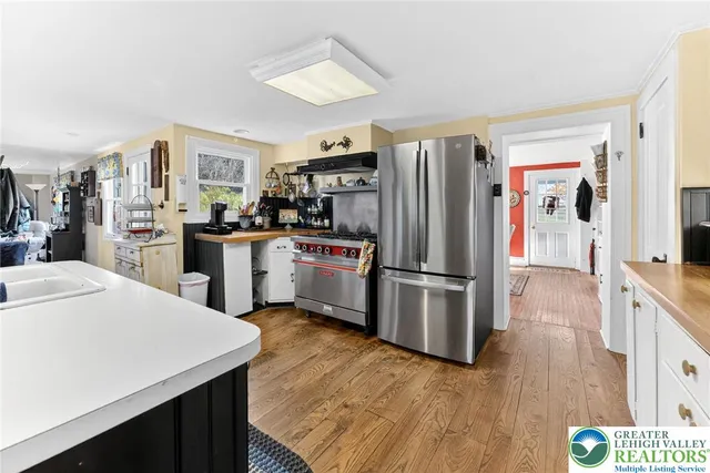 a bedroom with a bed and a dresser with mirror