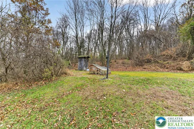 a view of yard with flowers and tree