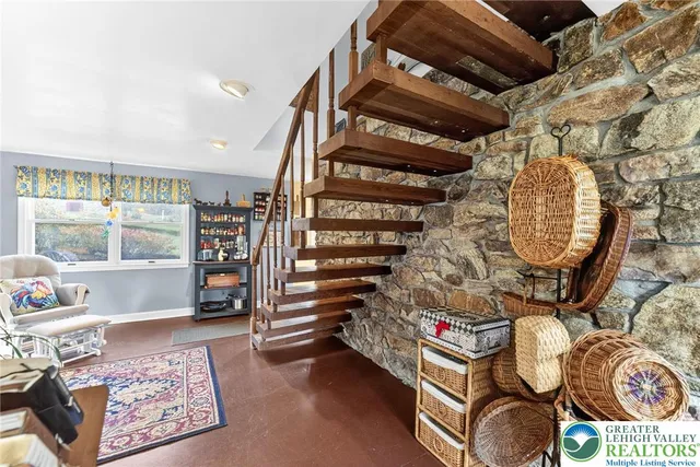 a kitchen with stainless steel appliances a refrigerator a stove a sink dishwasher and white cabinets with wooden floor