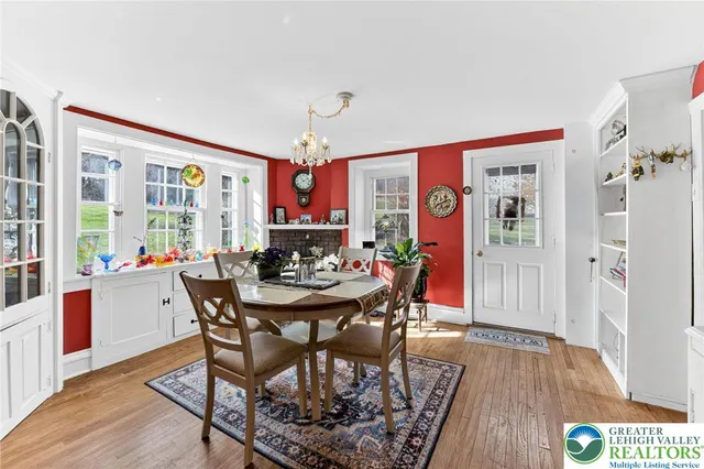 a living room with furniture a clock on wall and a window