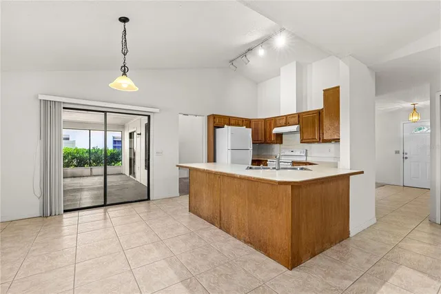 a view of kitchen with stainless steel appliances granite countertop a sink and a stove