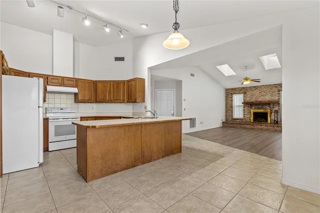 a large kitchen with cabinets and stainless steel appliances