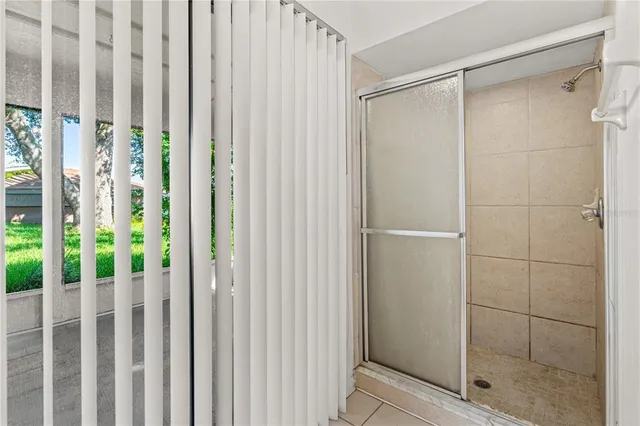 a bathroom with a glass shower door