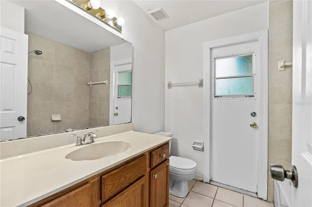a bathroom with a toilet a sink and a mirror