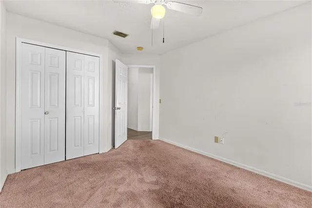 a view of a livingroom with a chandelier fan