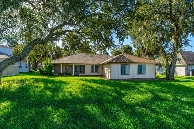 a front view of a house with yard and green space