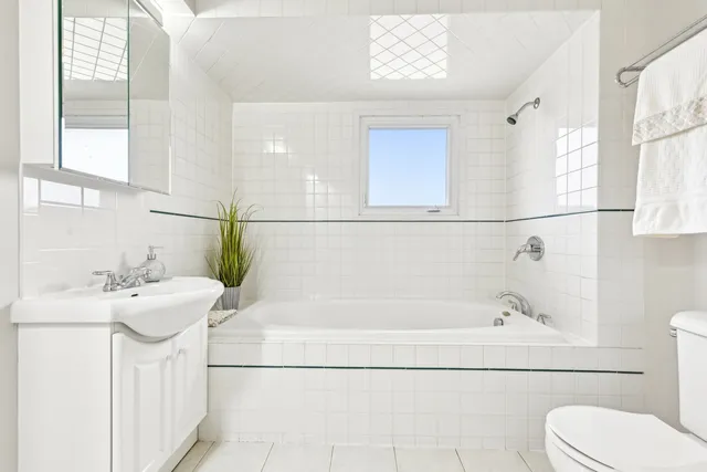 a bedroom with a large bed and a lamp