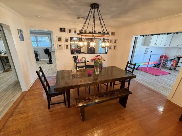 a view of a dining room with furniture and a chandelier