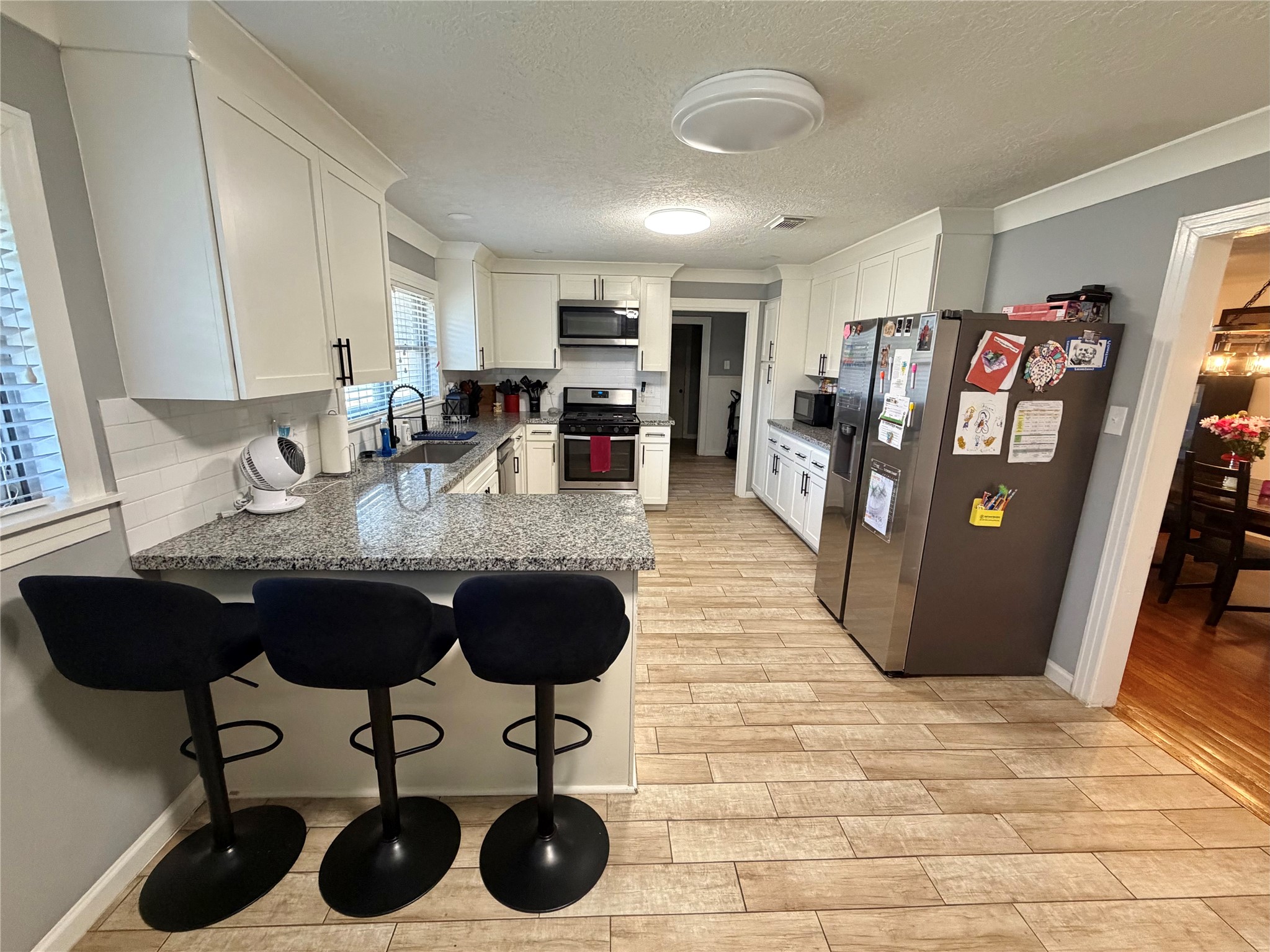 907 East Magnolia Street Angleton, TX 77515 - Photo 16 of 34 a view of a dining room with furniture and chandelier