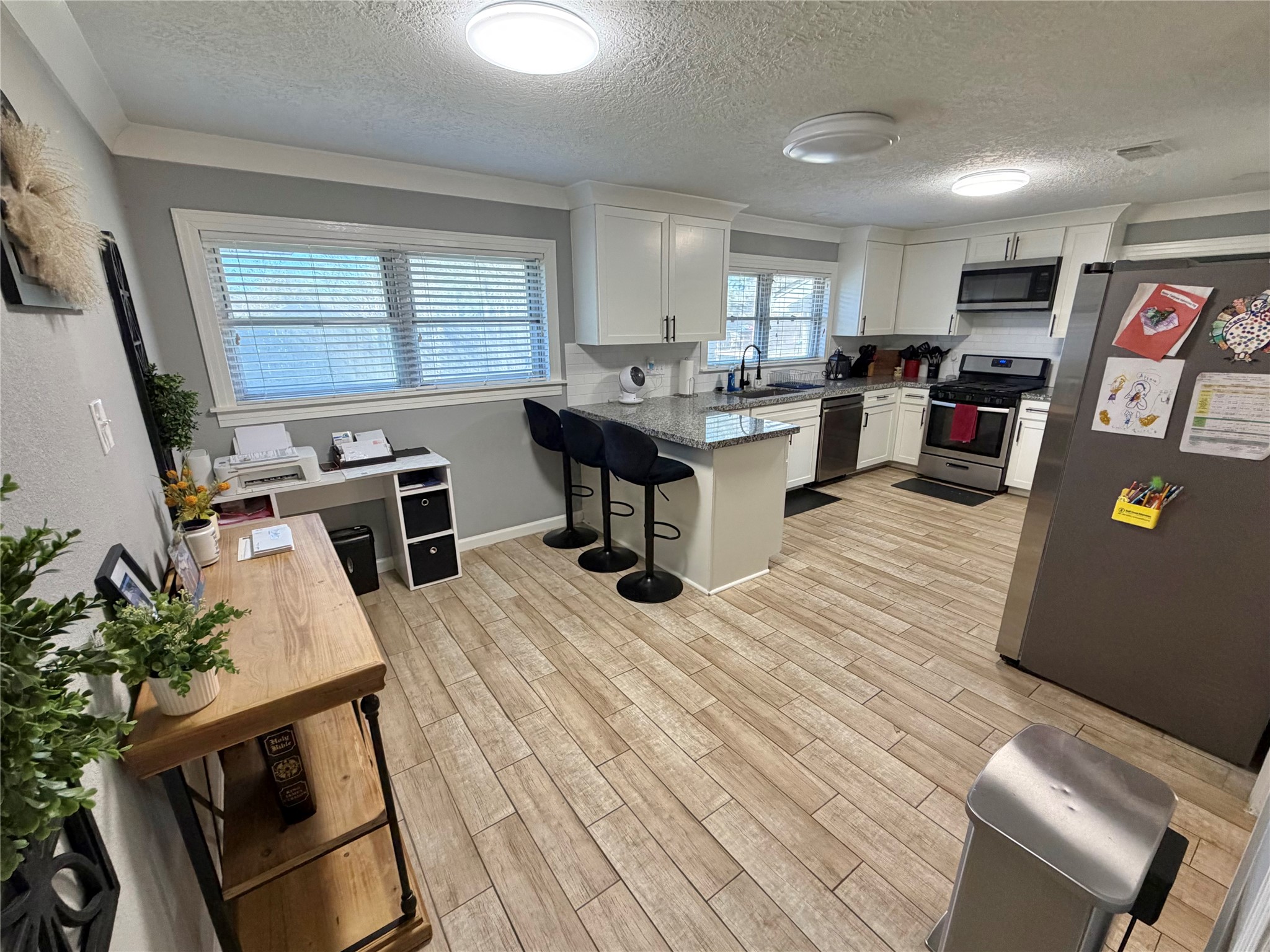 907 East Magnolia Street Angleton, TX 77515 - Photo 17 of 34 a living room with furniture and a wooden floor