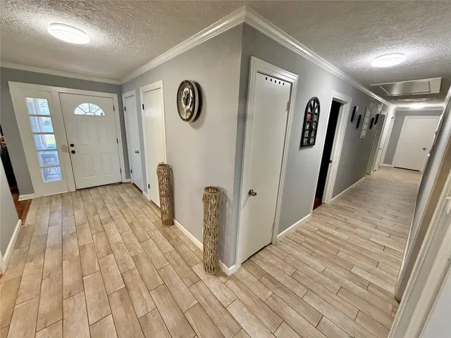 a view of hallway with wooden floor