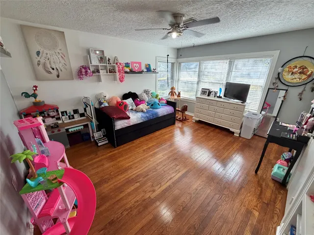 a bedroom with furniture and a wooden floor