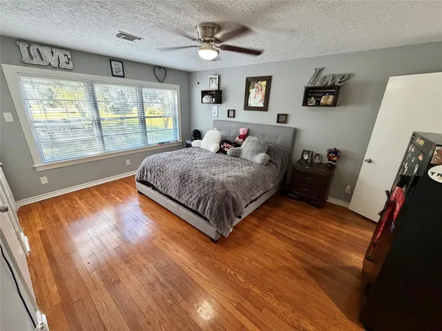 a spacious bedroom with a bed and a large window