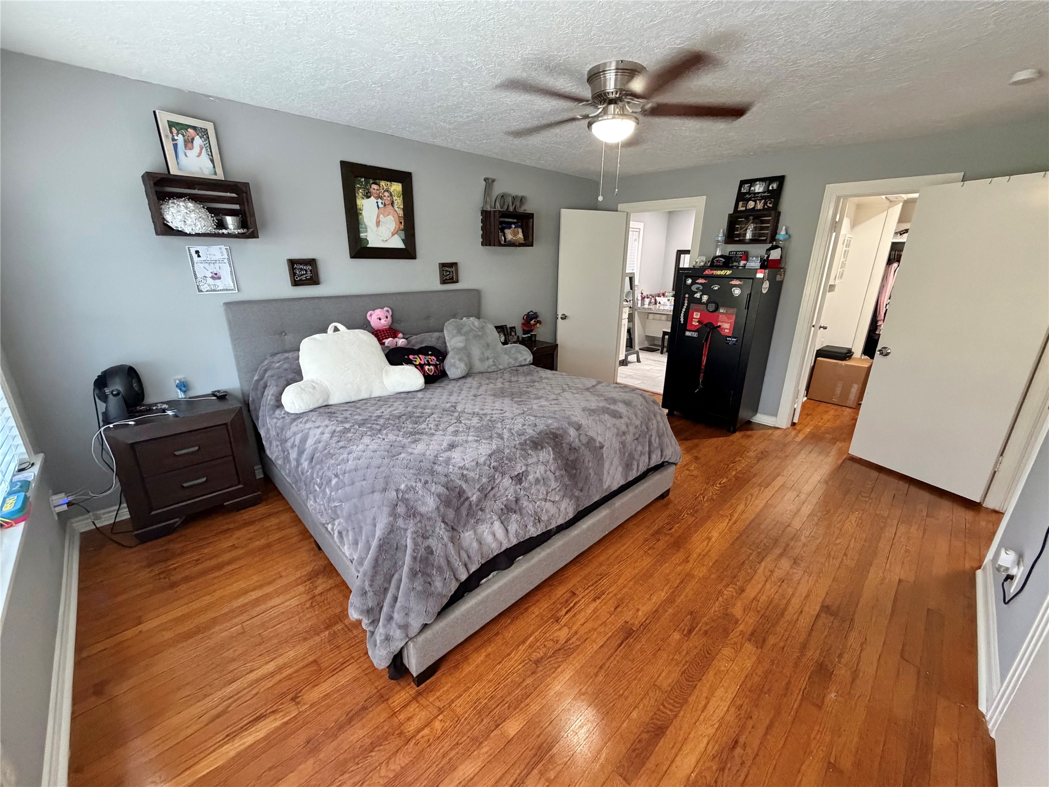 907 East Magnolia Street Angleton, TX 77515 - Photo 30 of 34 a bedroom with a bed and wooden floor