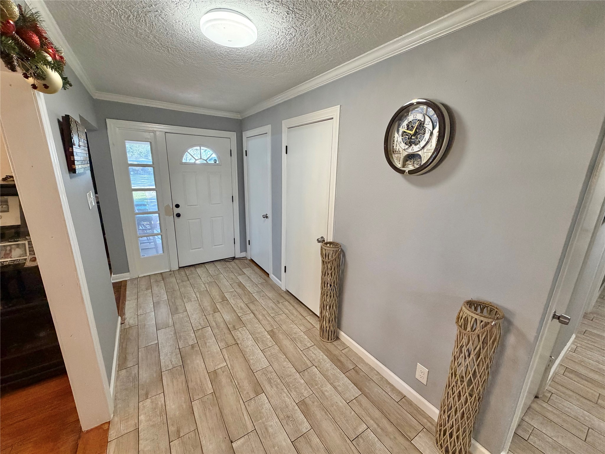 907 East Magnolia Street Angleton, TX 77515 - Photo 3 of 34 a view of a hallway with wooden floor