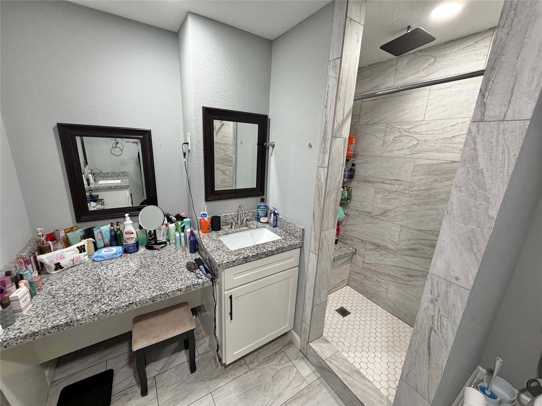 907 East Magnolia Street Angleton, TX 77515 - Photo 32 of 34 a bathroom with a granite countertop sink and a mirror