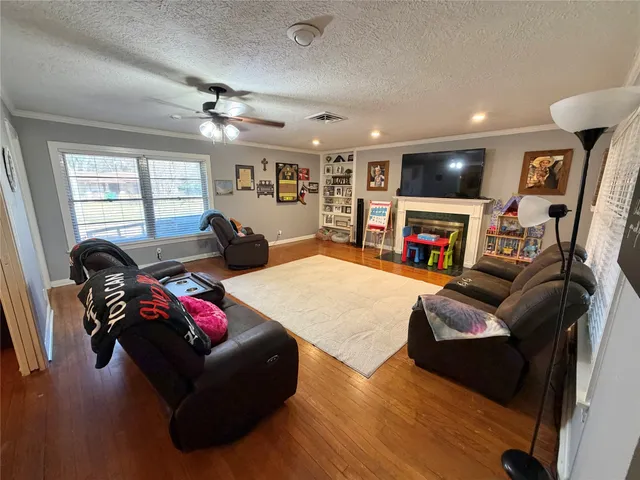 a living room with furniture fireplace and a flat screen tv
