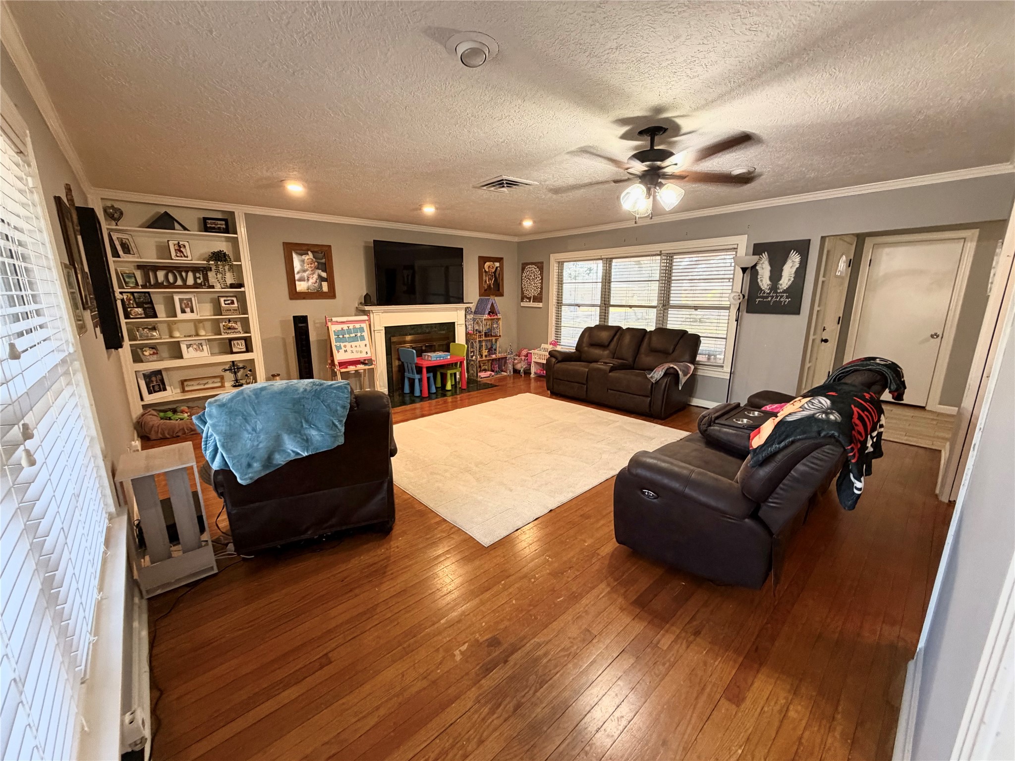 907 East Magnolia Street Angleton, TX 77515 - Photo 6 of 34 a living room with furniture ceiling fan and a wooden floor