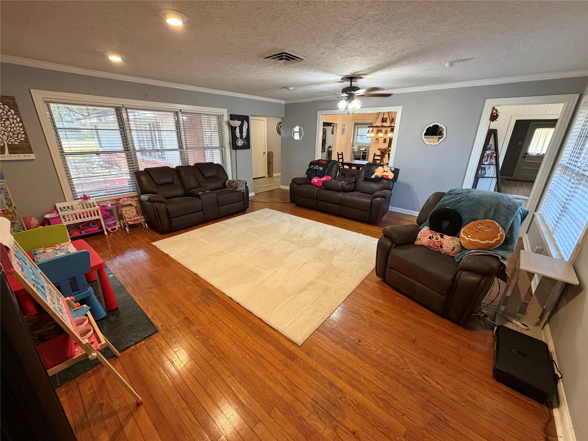 907 East Magnolia Street Angleton, TX 77515 - Photo 7 of 34 a living room with furniture window and wooden floor