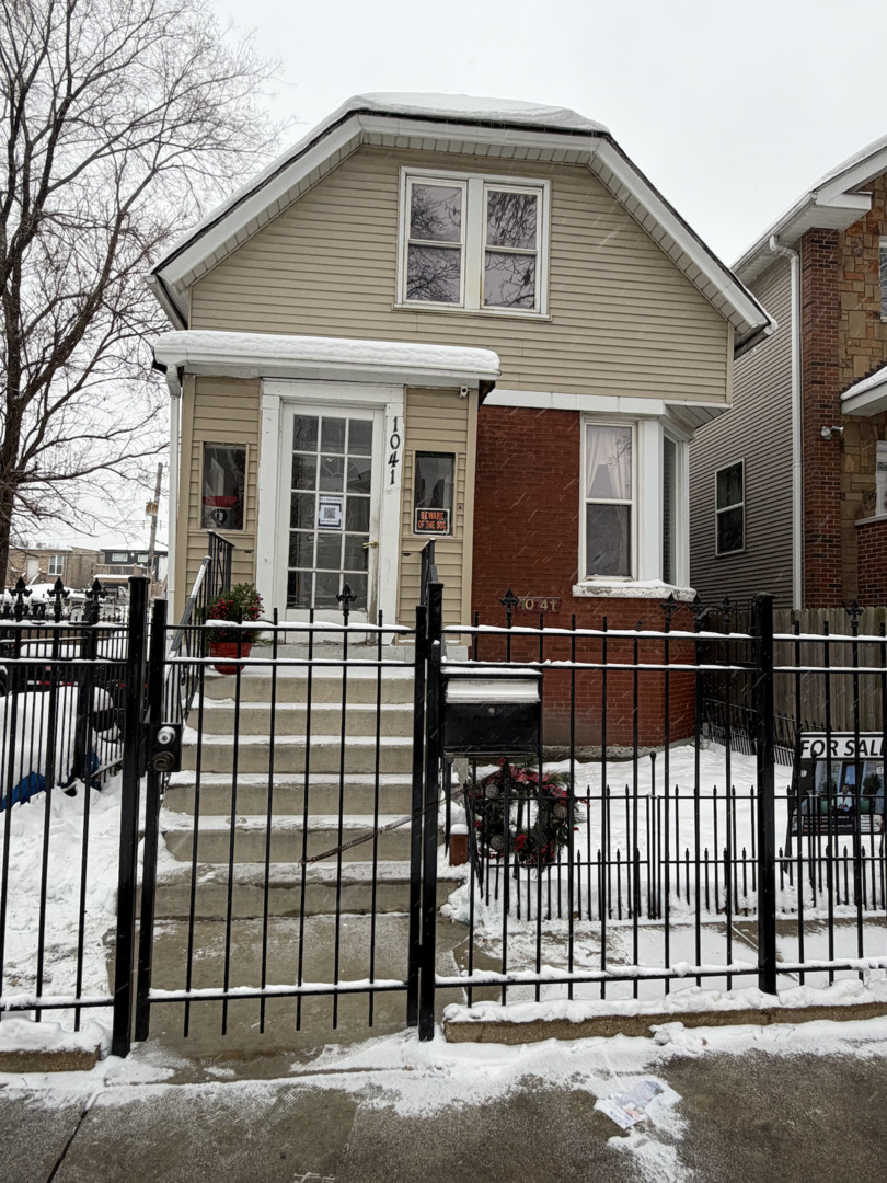 1041 North Ridgeway Avenue Chicago, IL 60651 - Photo 1 of 33 a view of a house with a outdoor space