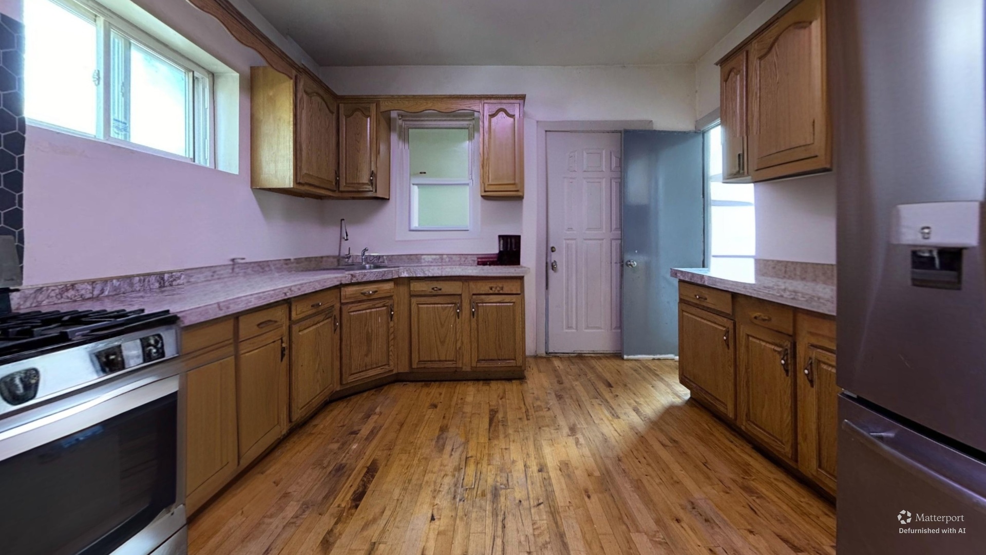1041 North Ridgeway Avenue Chicago, IL 60651 - Photo 11 of 33 a kitchen with stainless steel appliances granite countertop wooden cabinets and a stove top oven