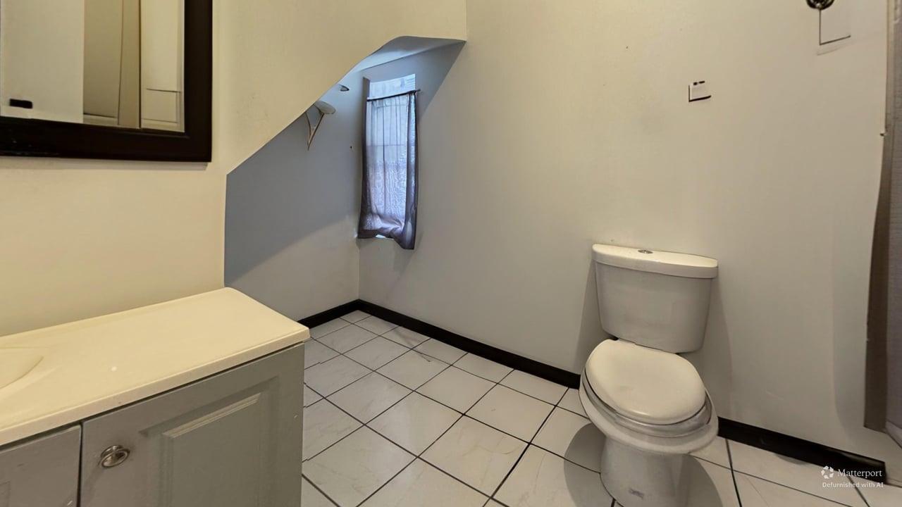 1041 North Ridgeway Avenue Chicago, IL 60651 - Photo 13 of 33 a bathroom with a sink and a toilet