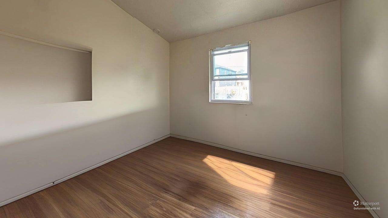 1041 North Ridgeway Avenue Chicago, IL 60651 - Photo 15 of 33 an empty room with wooden floor and windows