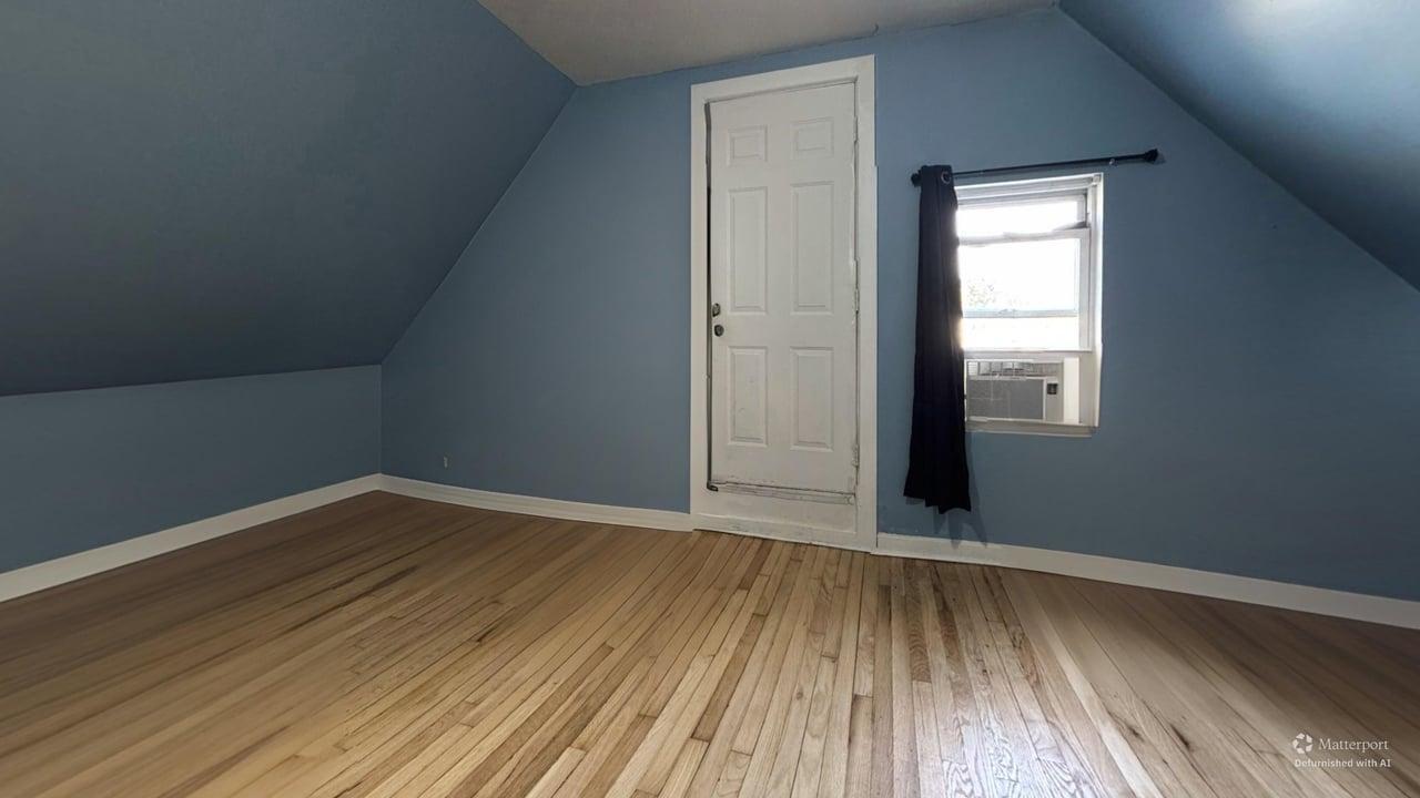1041 North Ridgeway Avenue Chicago, IL 60651 - Photo 18 of 33 a view of an empty room with wooden floor and a window