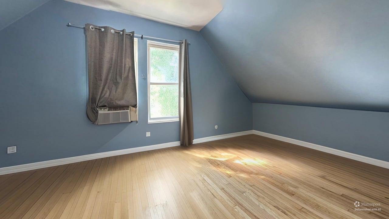 1041 North Ridgeway Avenue Chicago, IL 60651 - Photo 20 of 33 an empty room with wooden floor and windows