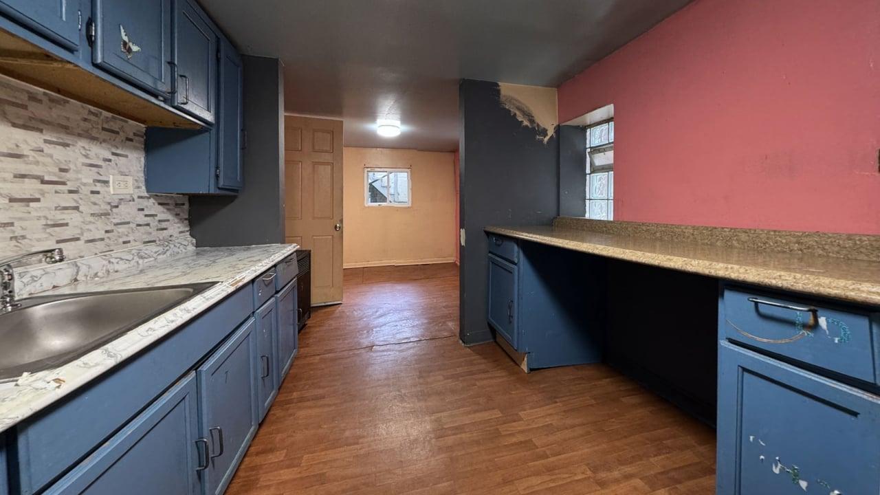1041 North Ridgeway Avenue Chicago, IL 60651 - Photo 24 of 33 a kitchen with stainless steel appliances granite countertop a sink counter space and wooden floor