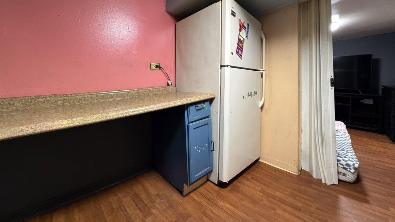 1041 North Ridgeway Avenue Chicago, IL 60651 - Photo 25 of 33 a view of a kitchen with wooden floor and a refrigerator