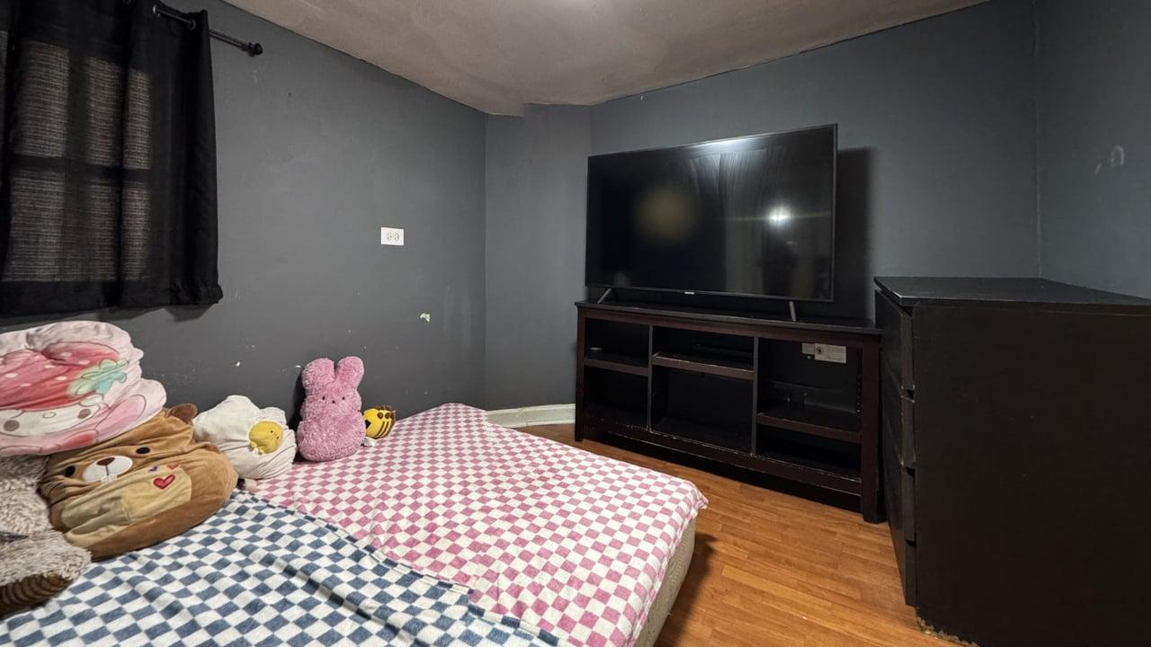 1041 North Ridgeway Avenue Chicago, IL 60651 - Photo 28 of 33 a bedroom with a bed and a television