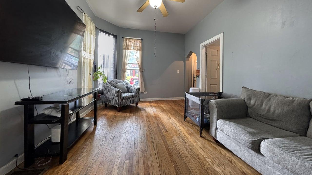 1041 North Ridgeway Avenue Chicago, IL 60651 - Photo 3 of 33 a living room with furniture and a wooden floor